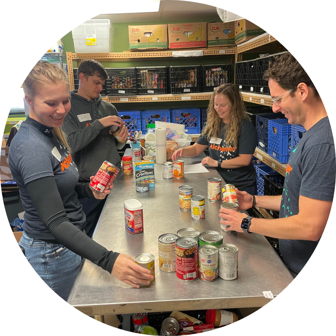 A corporate group sorting food donations while volunteering in the FISH Marketplace.